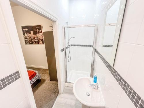 Meanwoodにある2 Bed - 2 Bath - Duplex Apartment next to LBU-Headingley Centre-YCC Arena-Families-Relocators - Long Stay Rates Availableのシャワーと洗面台付きのバスルーム