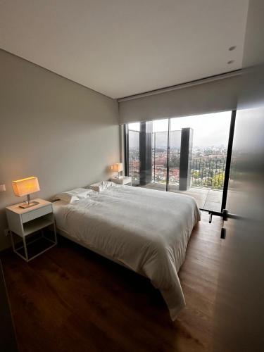 a bedroom with a large bed and a large window at New Douro 801 with parking in Vila Nova de Gaia