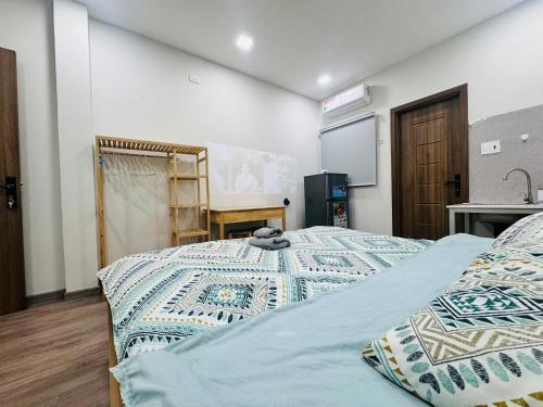 a bedroom with a bed and a projection screen at LoCo Studio with Netflix and Self Checkin in Ho Chi Minh City