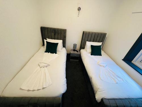 two beds sitting next to each other in a room at The New Valron Hotel in Blackpool