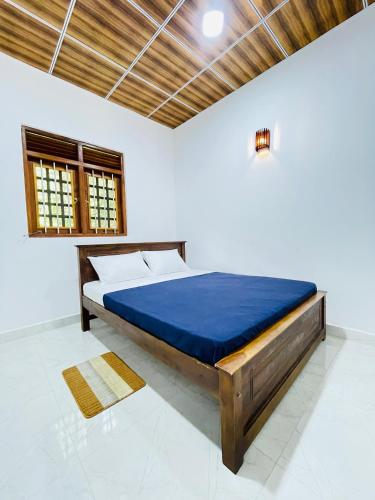 a bedroom with a large bed with a blue mattress at Paradise Villa in Weligama