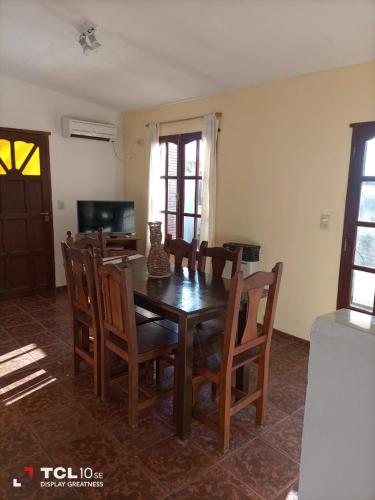a dining room with a wooden table and chairs at Solares de Capilla in Capilla del Monte