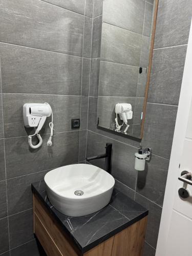 a bathroom with a white sink and a mirror at Fashion Residence Hill in Kopaonik