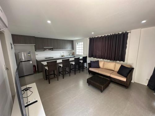 a large living room with a couch and a kitchen at Maha Villa - Sea View Island Retreat with private beach in Pinamihagan