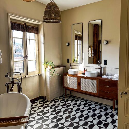 a bathroom with two sinks and two mirrors at Maison d'hôtes - Stay and Cook in Annonay