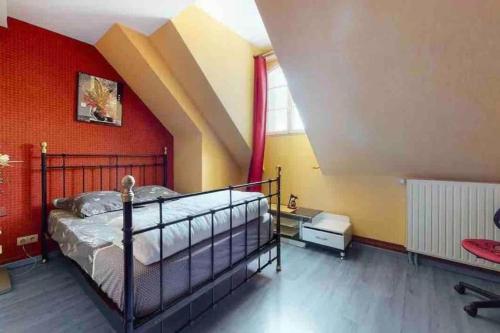 a bedroom with a bed and a red wall at Villa 320m2 a 1h30 de Paris in Montcresson