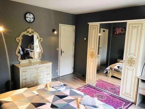 a bedroom with a bed with a mirror and a dresser at Villa 320m2 a 1h30 de Paris in Montcresson