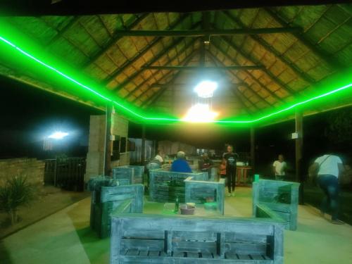 a group of people in a building with green lights at Graceland Recreation in Erasmus
