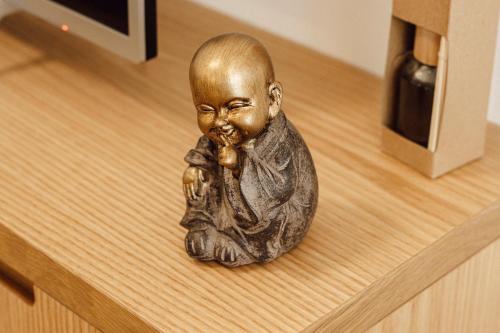 a small statue of a baby sitting on a table at Helia Luxury Apartment New Boulevard in Tirana