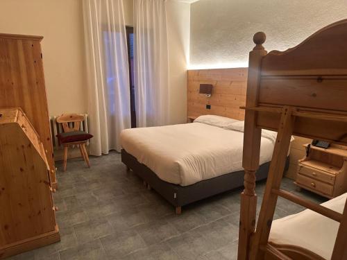 a bedroom with a bunk bed and a chair at Hotel Firenze in Fanano