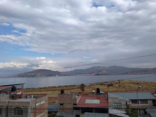 a view of a large body of water with buildings at Departamento ORILLAS DEL LAGO in Puno