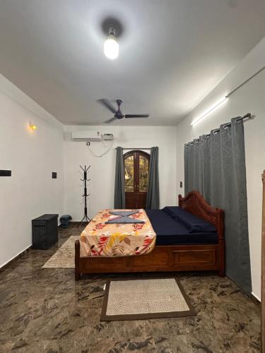 a bedroom with a bed and a ceiling fan at Mitra Homes Mandrem in Mandrem
