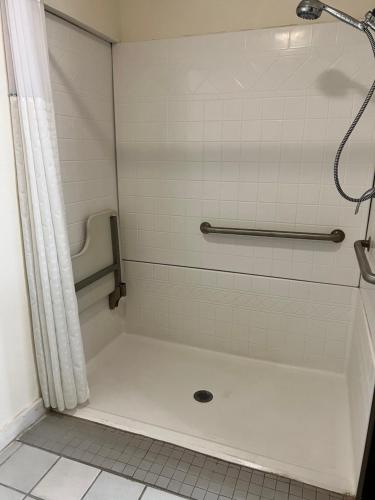 a bathroom with a shower with a tub and a shower at Super 8 by Wyndham Nebraska City in Percival