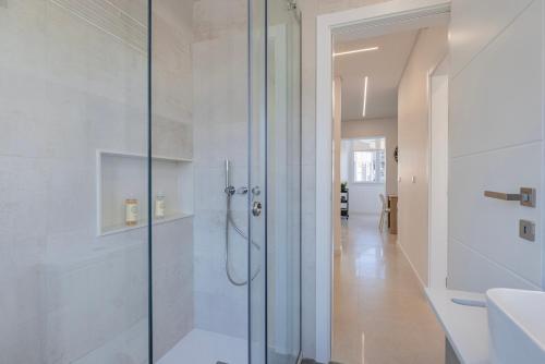 a bathroom with a shower with a glass door at New Apartment by the Metro - 4E in Lisbon
