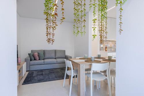 a living room with a table and a couch at New Apartment by the Metro - 4E in Lisbon