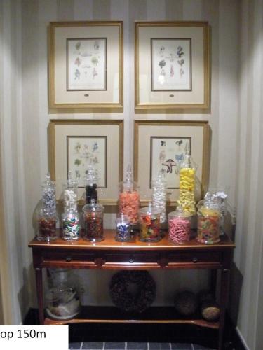 a table with a bunch of jars of candy at Guesthouse Recour in Poperinge