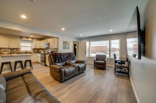 a living room with a couch and a kitchen at 4 Mi to Lake Michigan East Chicago Home with Grill in East Chicago