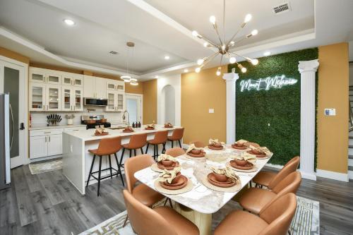 a kitchen and dining room with a table and chairs at Mount Melanin Spacious 4BD Home Sleeps 17 - Near NRG Stadium in Houston
