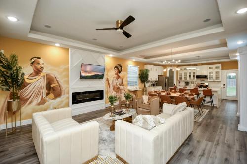 a living room with white furniture and a painting on the wall at Mount Melanin Spacious 4BD Home Sleeps 17 - Near NRG Stadium in Houston