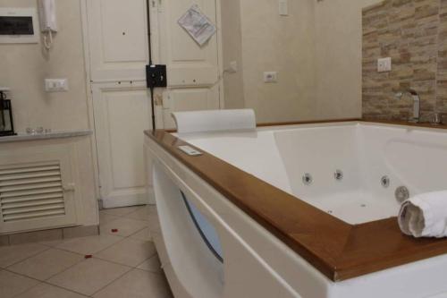 a bathroom with a large white tub in a room at LA FONTANA in Genzano di Roma
