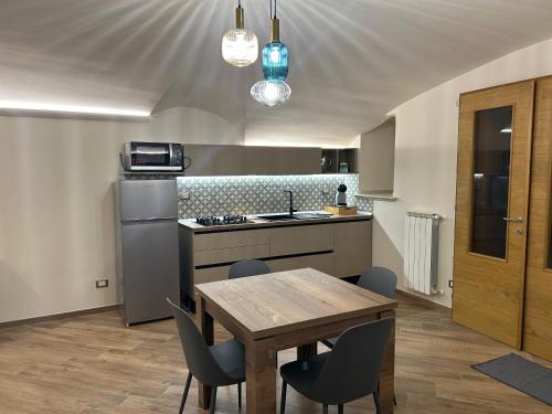 a kitchen with a table and chairs and a kitchen with a sink at Nolarium in Pescocostanzo