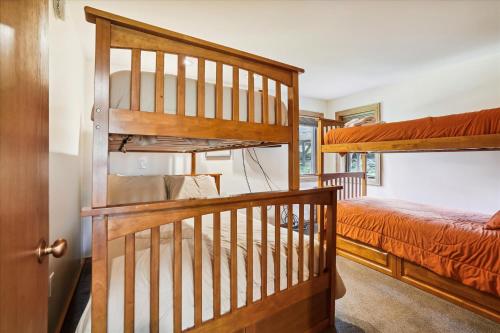 a bedroom with two bunk beds and a staircase at Highridge A16 Stunning Three Bedroom Condo with Whirlpool Bath, Heated Pool, and Game Room in Killington