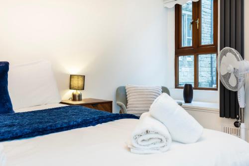a bedroom with a bed and a chair and a window at Modern 1 BR Apartment North London in London