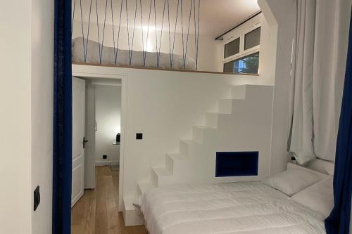 - une chambre avec un lit et un escalier dans l'établissement Cosy T3 in the heart of Popincourt, à Paris
