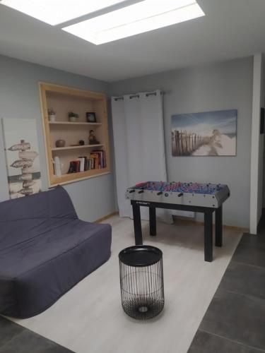 a living room with a couch and a table at maison lacanau in Lacanau