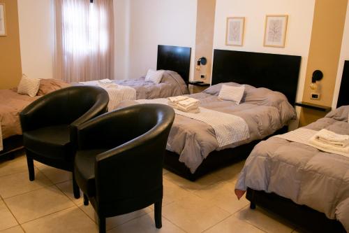 Postel nebo postele na pokoji v ubytování Hotel del Tren