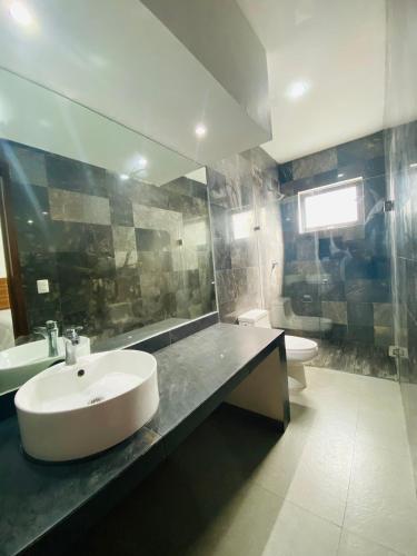 a bathroom with a sink and a toilet at Mía Center hotel in Playa del Carmen