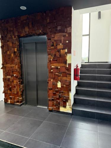 a building with a brick wall and a elevator at Mía Center hotel in Playa del Carmen
