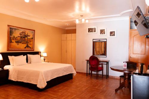 a hotel room with a bed and a table at Macacona Hacienda Hotel in Ica