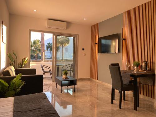 a living room with a couch and a table at Nissi Avenue Studios in Ayia Napa