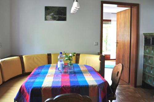 a dining room table with a colorful table cloth at Bunte Burg in Ebenweiler