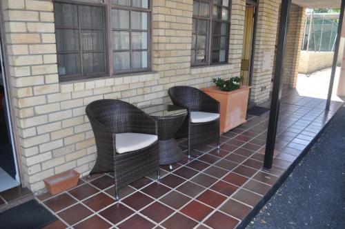 a group of chairs sitting on a patio at In Town Motor Inn in Taree