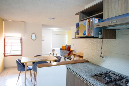 a kitchen with a counter top and a kitchen with a table at Bonitos departamentos frente a la Expo Guadalajara in Guadalajara