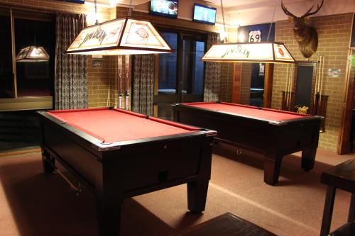 two pool tables in a billiard room with a mirror at Alpine Retreat Mt Buller in Mount Buller