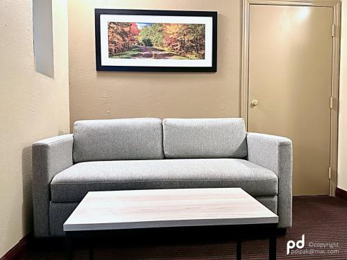 a living room with a couch and a coffee table at Travel Inn & Suites Flemington in Flemington