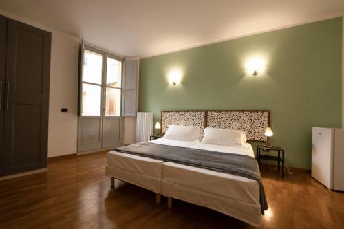 Postel nebo postele na pokoji v ubytování Residenza Palazzo Jona