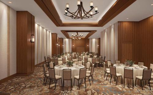 a banquet hall with tables and chairs and a chandelier at Snoqualmie Casino & Hotel in Snoqualmie