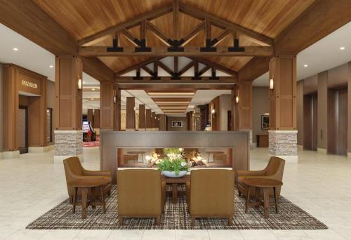 a lobby with a fireplace and a table and chairs at Snoqualmie Casino & Hotel in Snoqualmie