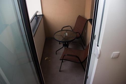 a small table and a chair in a small room at Apartman Doboj in Doboj