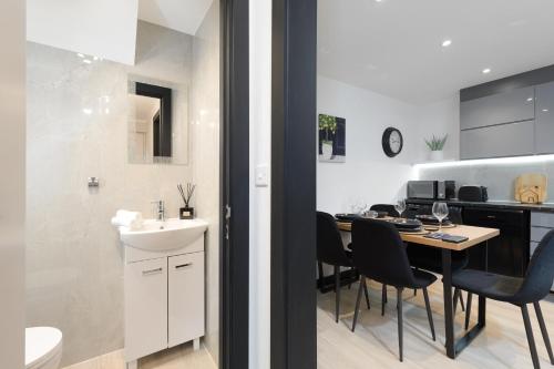a kitchen and dining room with a table and chairs at Bright & Stylish Home Nestled at the Edge of Exmoor in Tiverton