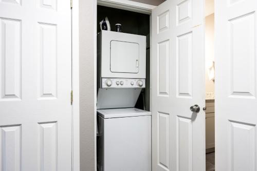 a kitchen with a white refrigerator and a white door at Hidden Creek Canyons Retreat, Alpine Charm, Private Hot Tub, Sleeps 8, Cozy Fireplace, in Park City