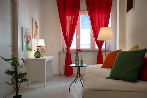 a living room with red curtains and a couch at Villa Vera in Salerno
