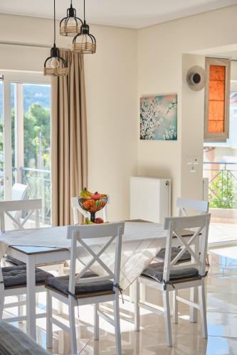 a dining room with a table and chairs at ATHENS VILLA KROPIA #AthensAirport #AirView #Sunrise in Koropíon