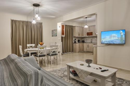 a living room with a couch and a table and a kitchen at ATHENS VILLA KROPIA #AthensAirport #AirView #Sunrise in Koropíon