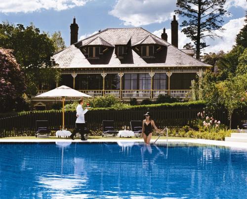 a man and a woman standing in a swimming pool at Lilianfels Blue Mountains Resort & Spa in Katoomba