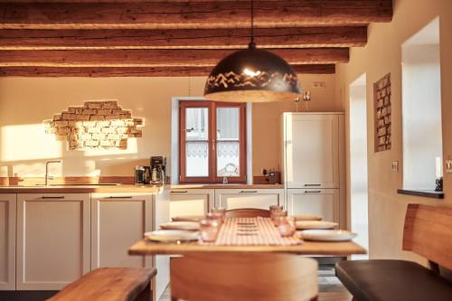 a kitchen with a wooden table in a room at Haus Herzbluat in Peiting